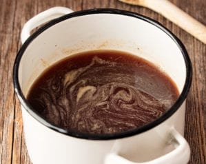 lamb gravy in a white pan