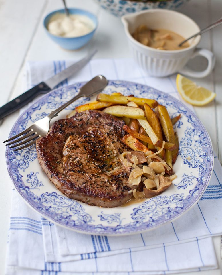 Ultimate steak and chips with a rich mushroom sauce delicious. magazine
