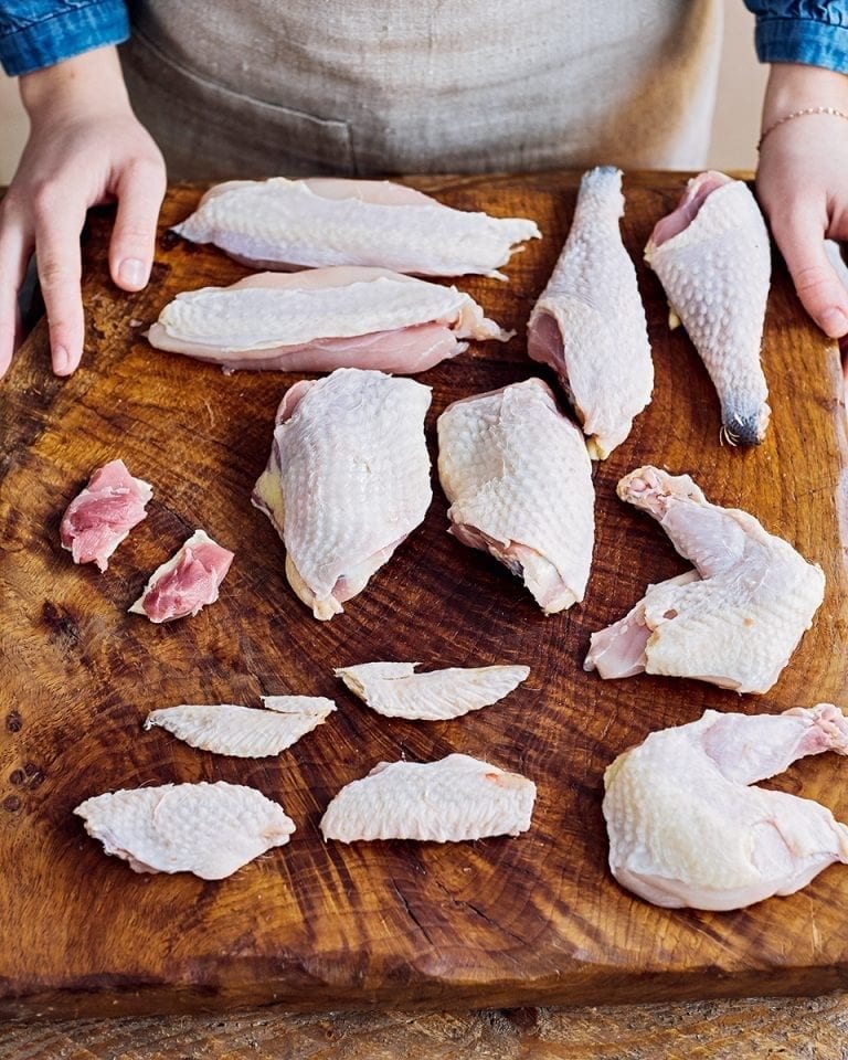 Chopping board with pieces of chicken