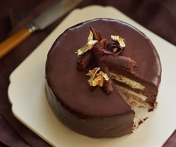 Dark chocolate orange mousse cake with gold leaf and glaçage topping