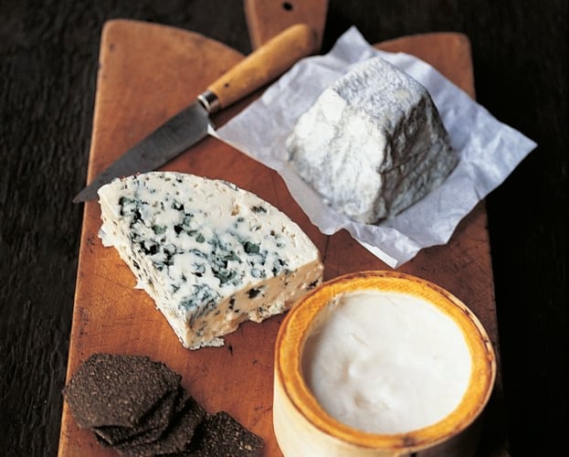 A French cheeseboard - cheeses on a wooden board