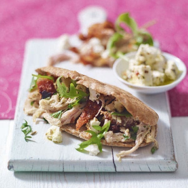 Shredded pork pittas with crumbled feta and coriander