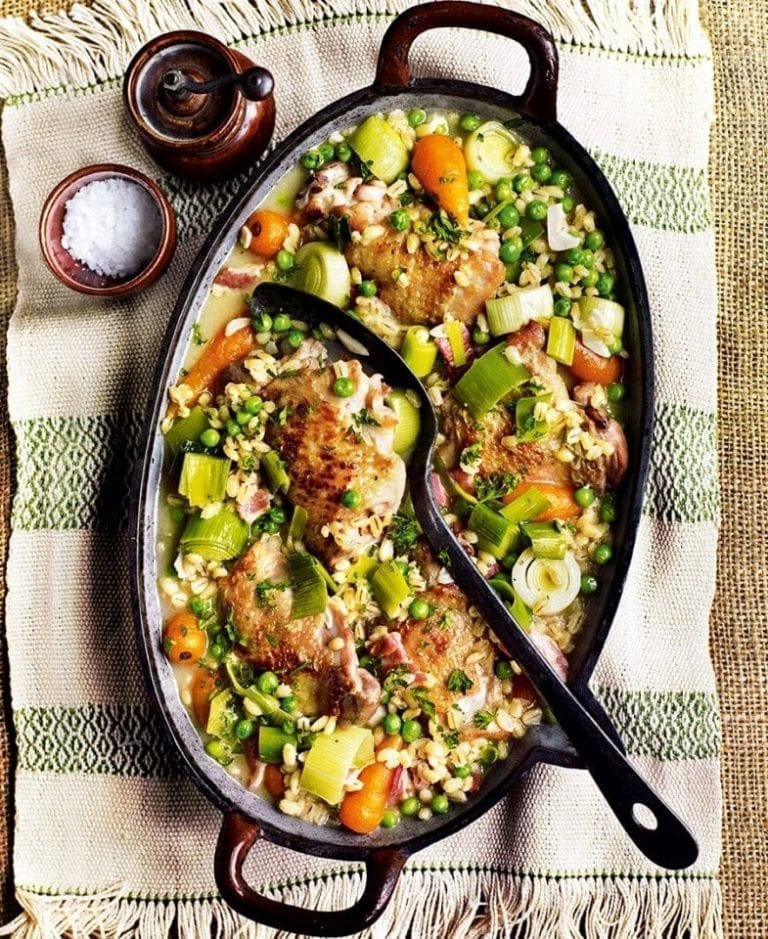 Cider-braised chicken thighs with pearl barley, bacon, carrots and peas