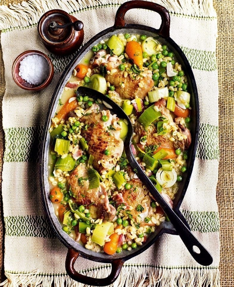 Ciderbraised chicken thighs with pearl barley, bacon, carrots and peas