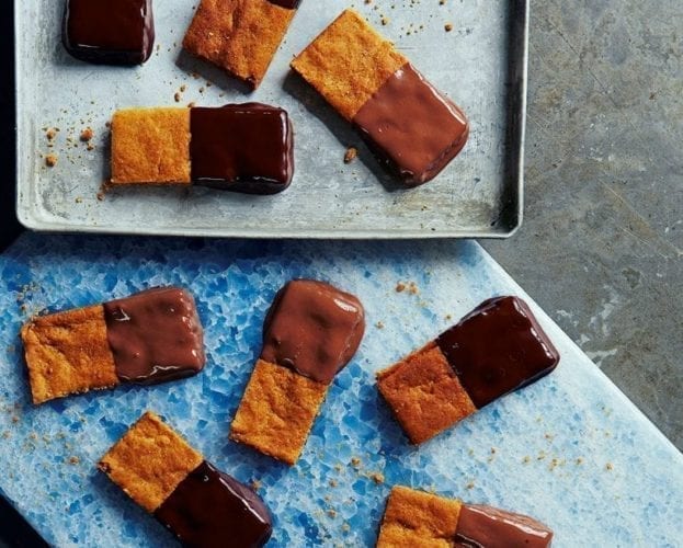 Oblong-shaped ginger biscuits, half-dipped in chocolate