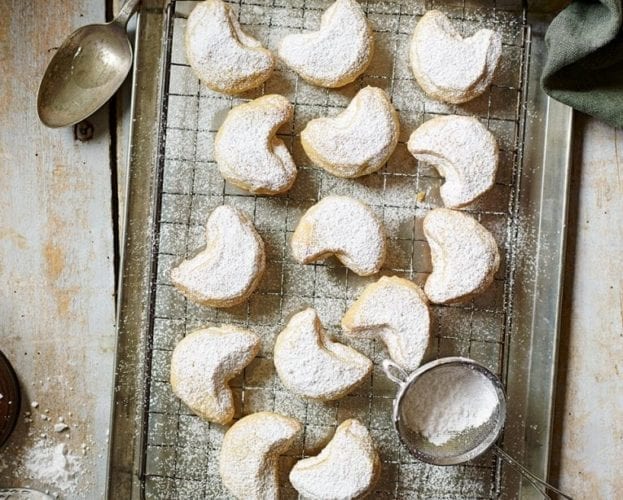 Kourabiedes - crescent shaped biscuits shown on a wire rack