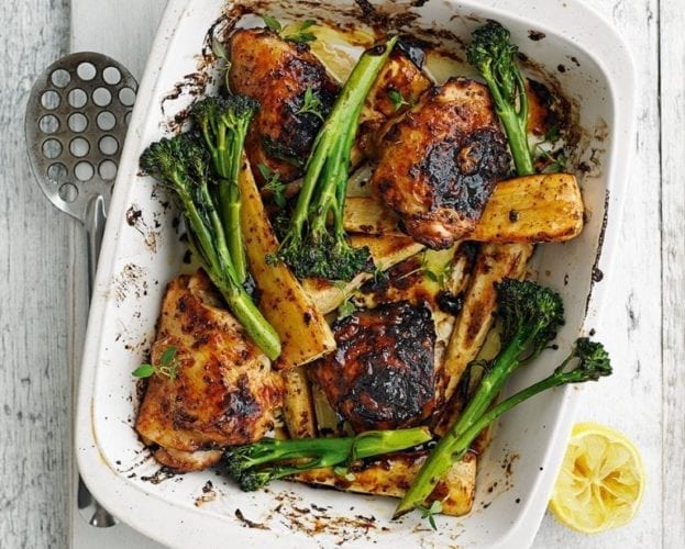 Honey and mustard chicken traybake, shown in a white serving dish