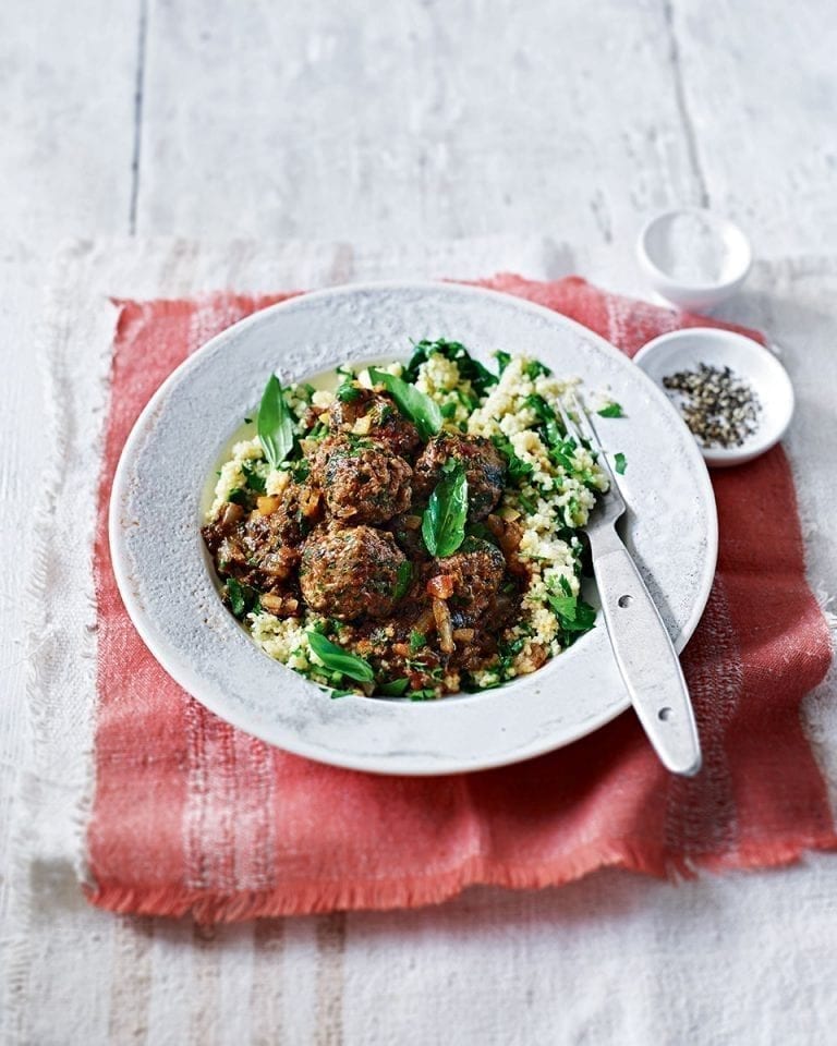 Meatballs in spinach and tomato sauce with herby couscous