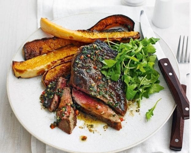 Slices of sirloin steak shown cooked alongside roasted squash