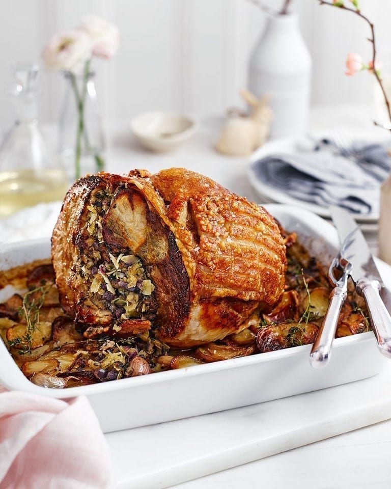 Almond and herb stuffed leg of pork with confit potatoes, apples and ...