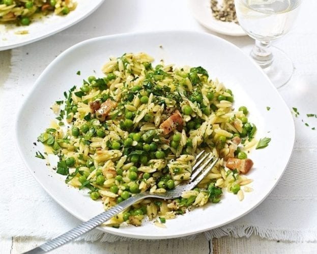 A green and colourful orzotto recipe, shown in a white bowl