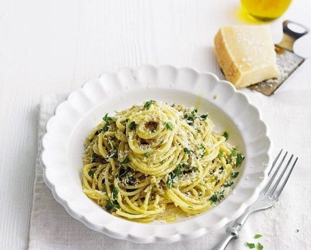Artichoke pasta shown in a white fluted bowl