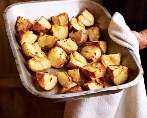 Twice roasted potatoes in a roasting pan