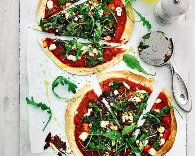 Two pizzas with goat's cheese and onion toppings