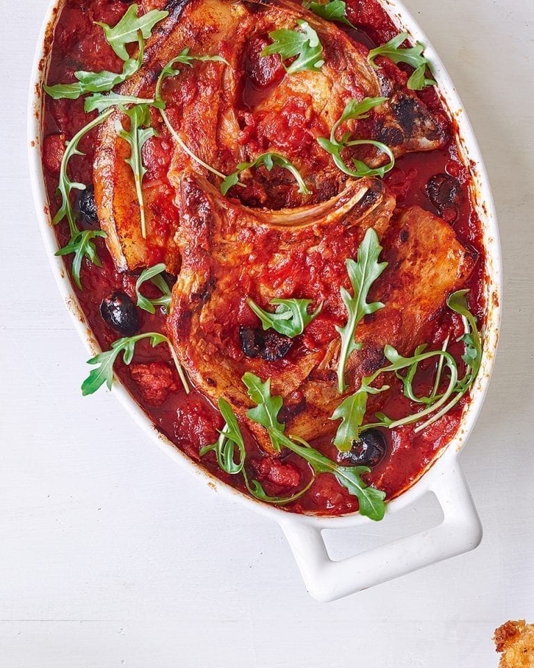 Pork chops baked in chorizo and black olive tomato sauce