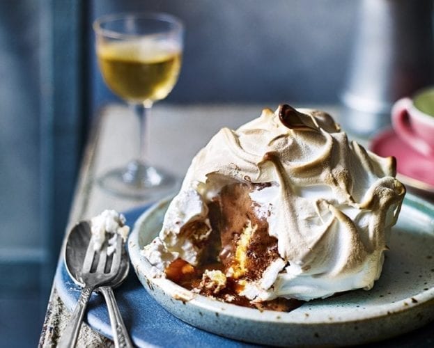 A baked Alaska shown on a plate on a table