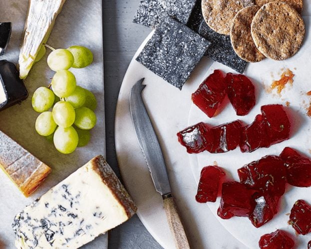 Plum membrillo shown in cubes on a plate
