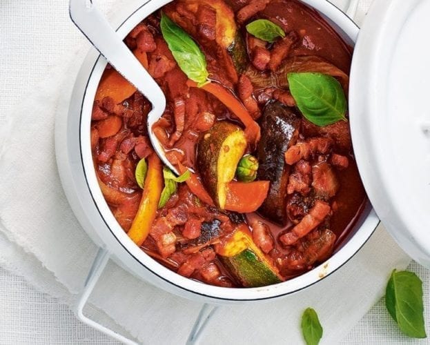 Ratatouille with bacon in a white pan
