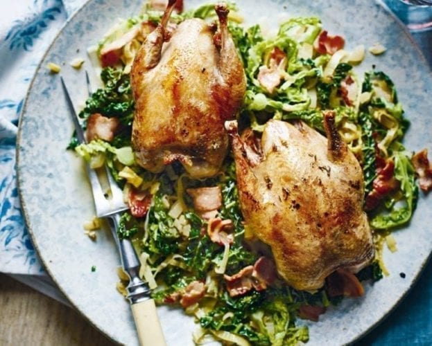 Two cooked partridges shown on a plate