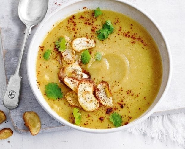 Curried parsnip soup in a white bowl