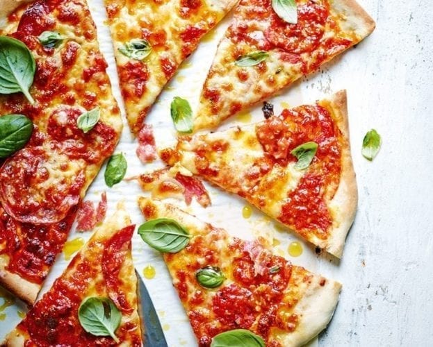Sloppy Joe pizza shown cut into slices