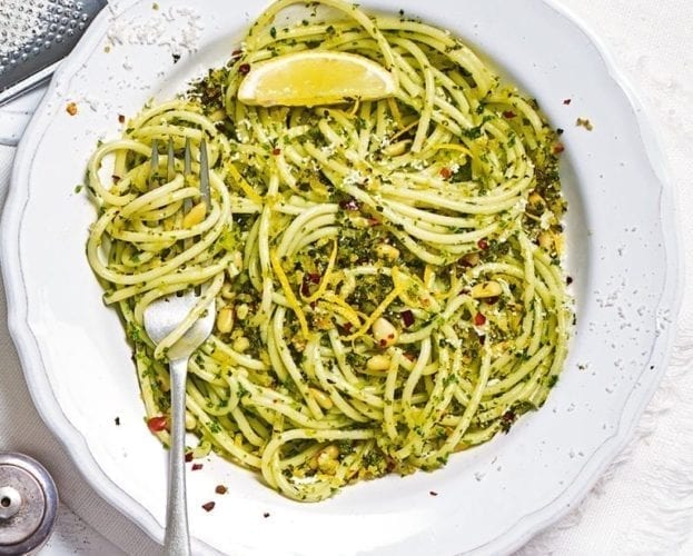 Spaghetti with kale pesto on a white plate