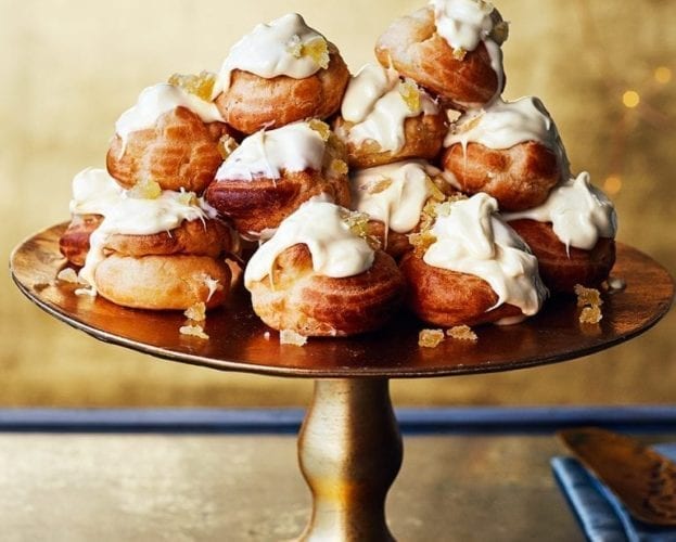White chocolate profiteroles in a tower on a plate