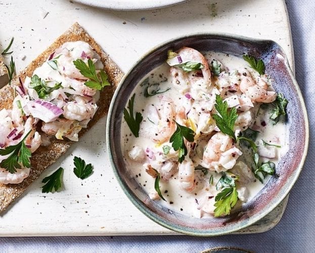 Skagen prawn cocktail shown on a grey plate