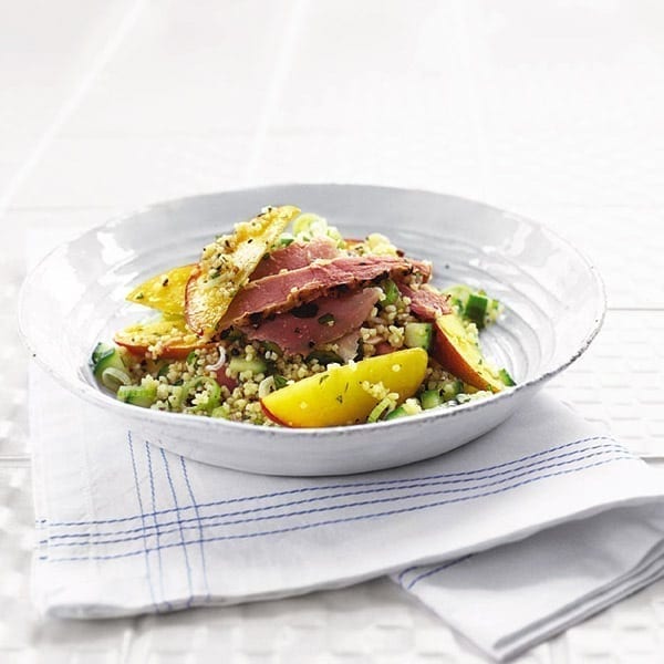 Ham with a peach and coucous salad