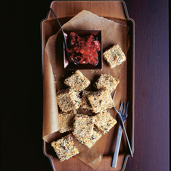 Polenta, olive and sesame cubes with caramelised peppers