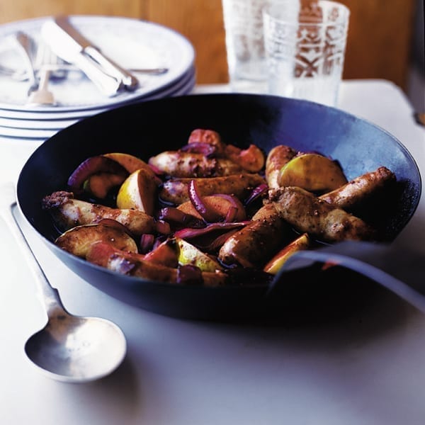 Bangers and mash with mustard gravy and apple wedges