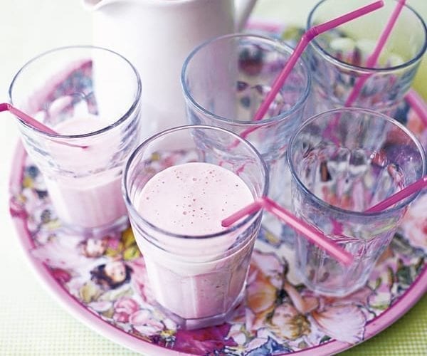 Glasses of milkshake on a colourful tray