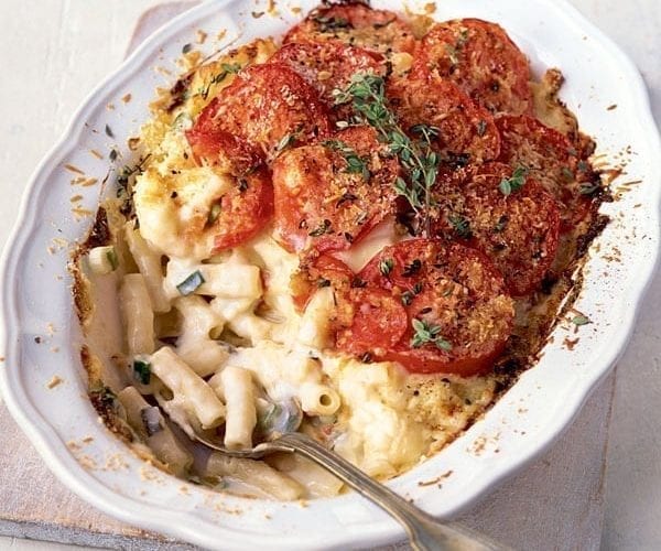 Tomato-topped cauliflower cheese, shown in a pretty tray