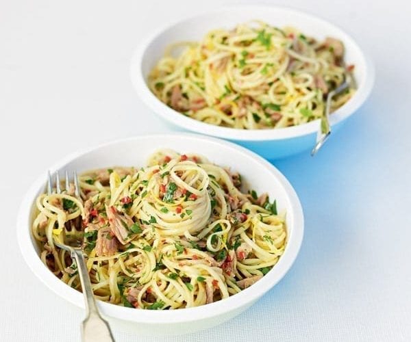 Tuna linguine in a white bowl with a fork in it