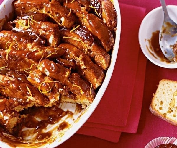 Sticky toffee pudding shown in a white dish
