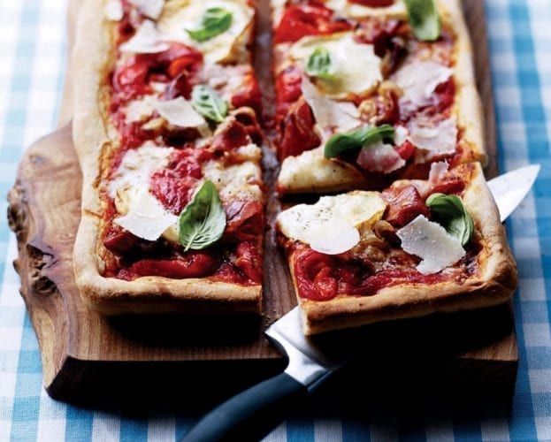 Rectangular-shaped pizza topped with goat's cheese and grana padano