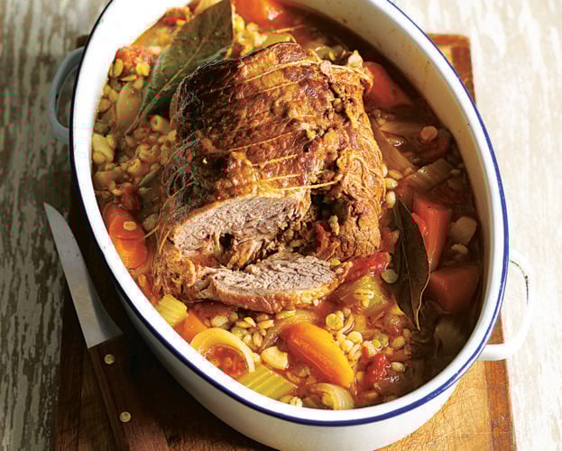 Beef stew made with brisket, shown in a white casserole dish