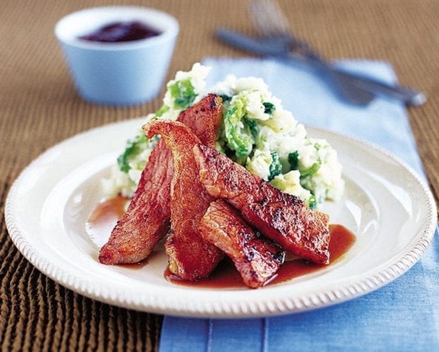 Gammon with colcannon on a white plate