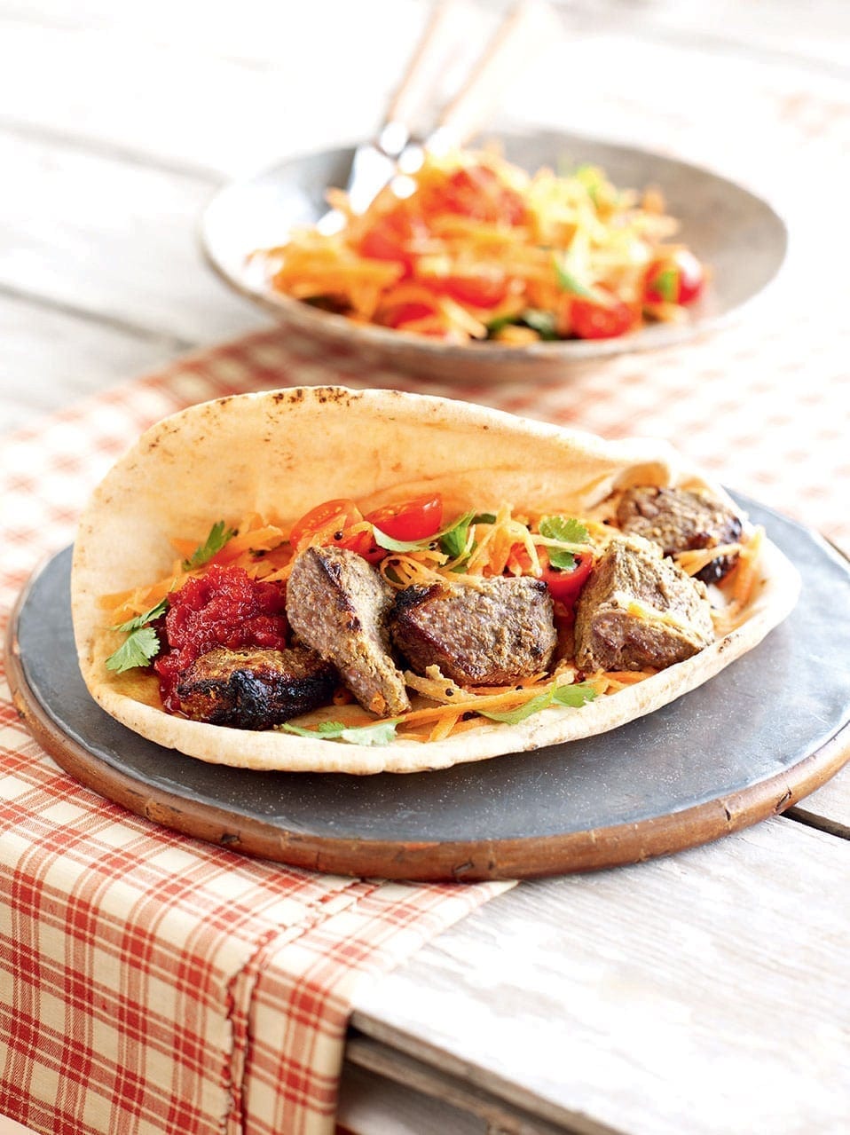 Lamb tikka with spiced carrot salad in flatbread-image
