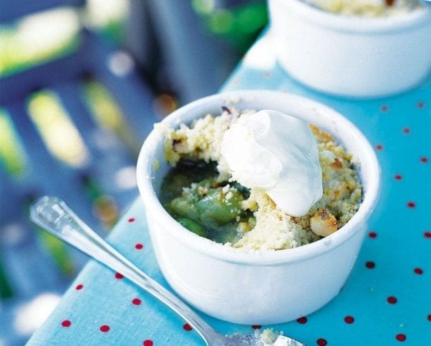 Individual gooseberry crumbles in white ramekins