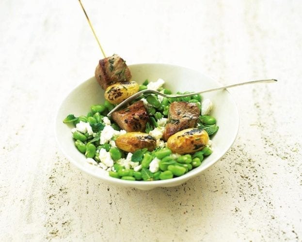 Pork kebabs on minted broad beans with feta