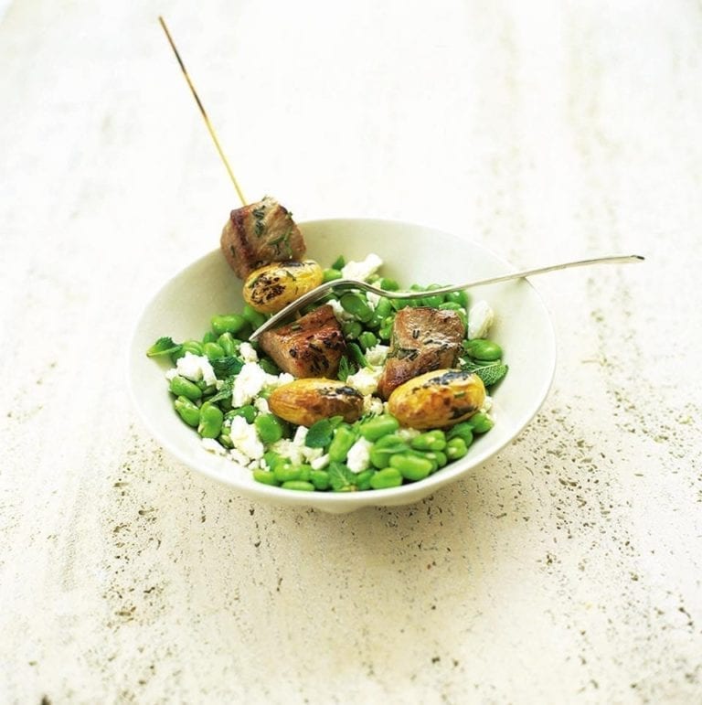 Pork kebabs on minted broad beans with feta