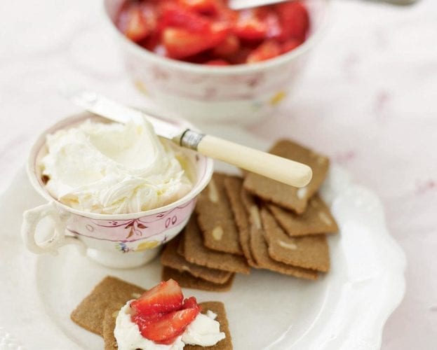 Strawberries with mascarpone butter and almond thins, served on a pretty plate