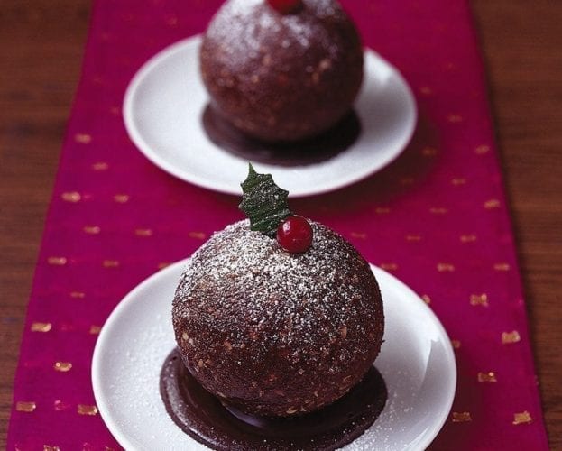 Round chocolate and cranberry Christmas puddings