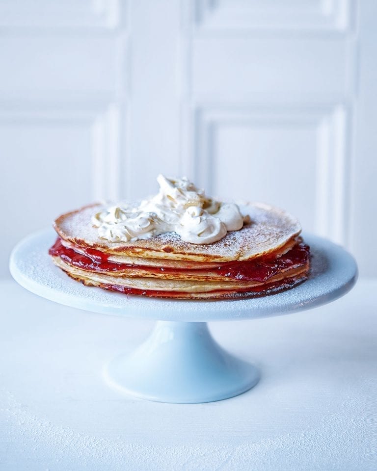 Pancakes stacked on a blue cake stand