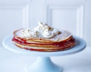 Pancakes stacked on a blue cake stand
