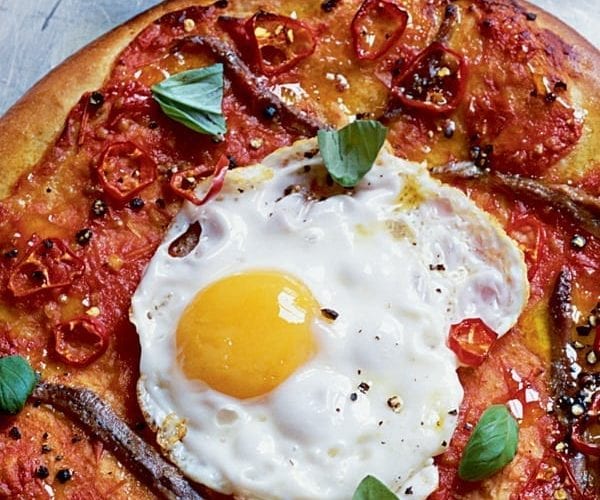 Anchovy and fried egg pizzas