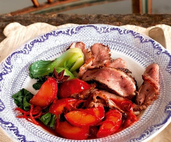 Duck with spiced plums shown on a plate