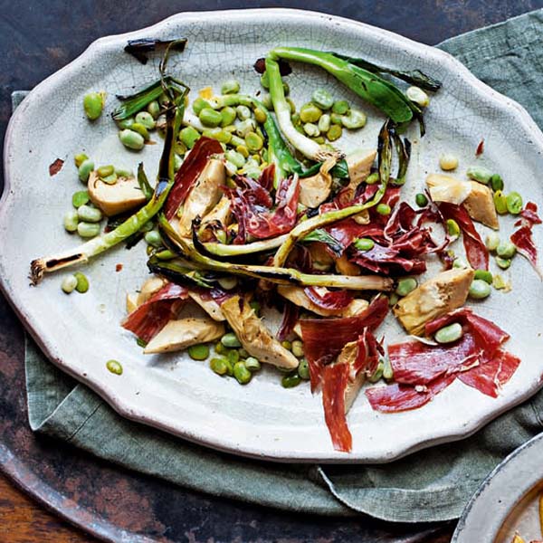 Grilled artichoke hearts with jamón, broad beans and spring onions