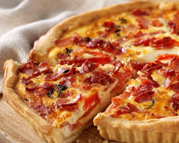 Cheese, bacon and tomato quiche cut into slices